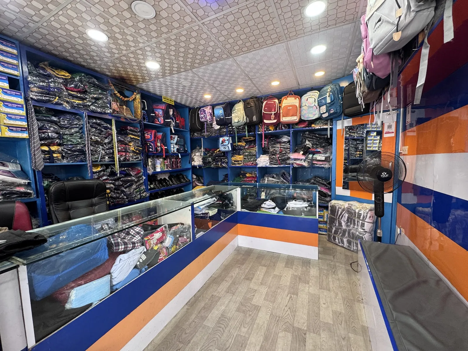 Interior of Pragati Venus Uniform with packaged garments and school bags on display