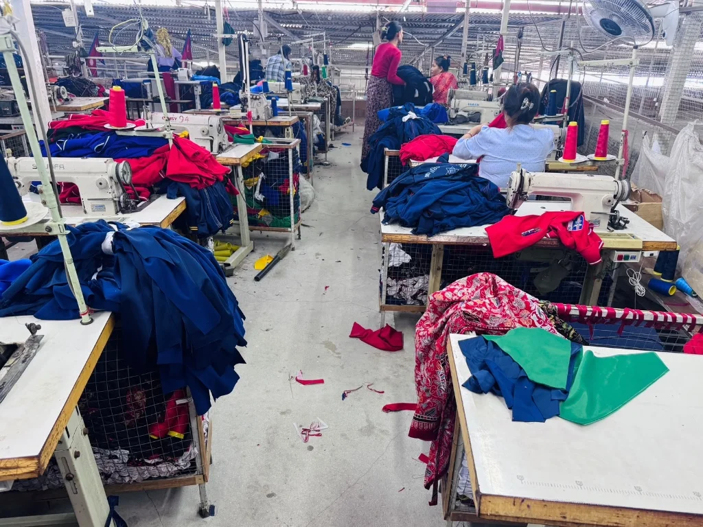Tracksuit sewing floor operators assembling active sportswear at Pragati Venus Uniform